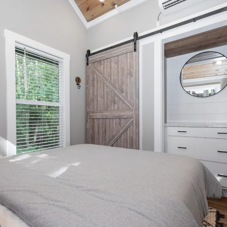 Interior view of the bedroom room of a luxurious Coldwater cabin at Ocoee River Mountain Cottages