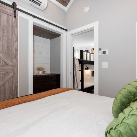 Interior view of the bedroom room of a luxurious Swayback cabin at Ocoee River Mountain Cottages